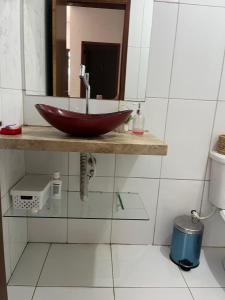 a bathroom with a red bowl sink on a shelf at Casa Flor e Ser Rua Onezinda da Costa Barros ,80 in Parnaíba