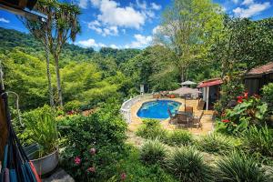 a backyard with a swimming pool and a garden at Rincón del Colibrí in La Vega +77 photos