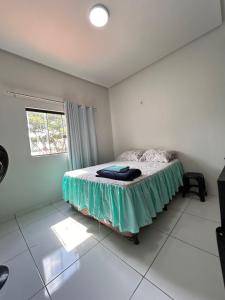 a bedroom with a bed in a room with a window at Casa Lima in Imperatriz