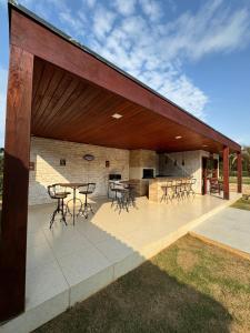 a pavilion with tables and chairs on a patio at Pousada Villarejo in Monte Verde