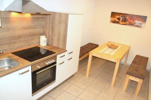 a kitchen with a table and a stove top oven at Doppelzimmer - Monteurswohnung - Arbeiterwohnung 4-8 Personen in Plaue