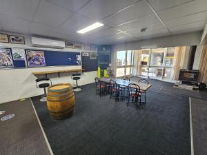 a room with a table and chairs and a barrel at Commercial Hotel in Birchip +2 photos
