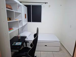 a small bedroom with a bed and a desk at Apartamento 2 Quartos com Piscina e Garagem in Maceió +12 photos