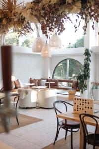 a room with tables and chairs and windows at The Tamborine - Boutique Hotel in Mount Tamborine