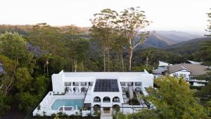 an aerial view of a white house with a swimming pool at The Tamborine - Boutique Hotel in Mount Tamborine