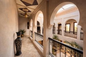 a hallway of a house with a vase on the floor at Private Riad Alemania in Marrakesh - Pool - Rooftop in Marrakesh +7 photos