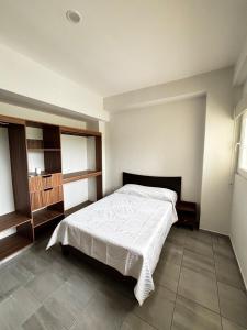 a bedroom with a white bed in a room at Cabo Marino Apartment, Pool, Beach and Marina in Conchal