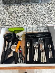 a drawer filled with utensils on a counter at Cabo Marino Apartment, Pool, Beach and Marina in Conchal +26 photos