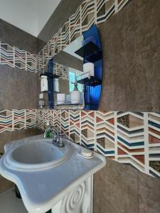 a bathroom with a sink and a mirror at Palm Breeze Villa in Green Island +29 photos