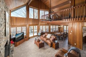 a large living room with a couch and a tv at The Buc's Den in Beech Mountain