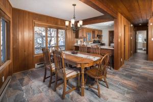 a dining room with a wooden table and chairs at The Buc's Den in Beech Mountain