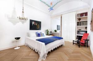 a bedroom with a bed in a white room at Villa Lalen Sorrento Private Luxury Residence with Garden, Terrace & Jacuzzi in Sorrento