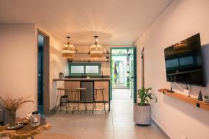 a kitchen with a bar and stools in a room at Parallelo Loft Salento P1 in Salento +25 photos