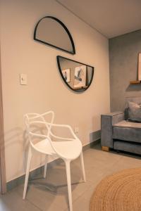 a white chair in a room with a mirror at Parallelo Loft Salento P1 in Salento