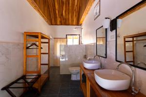 a bathroom with two sinks and a toilet at Sook Village in Nongkhiaw