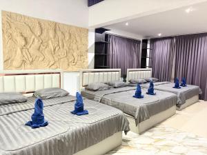 three beds in a room with blue decorations on them at เกาะช้าง พูลวิลล่า วิวทะเล 2 in Trat +37 photos