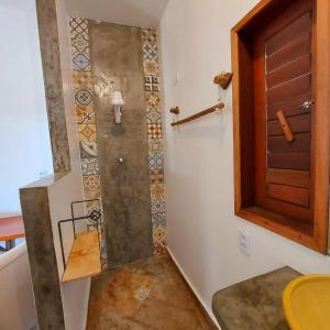a shower in a bathroom with a wooden door at Casa Nossa Preá in Prea +33 photos