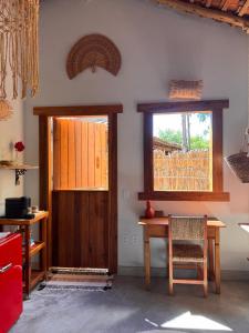 a dining room with a table and a window at Casa Kaûma in Corumbau