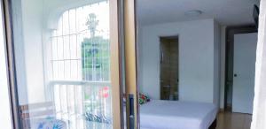a room with a window with a bed in it at Hospedaje s o s in Cali