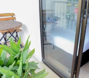 a sliding glass door with a table and a chair at Hospedaje s o s in Cali
