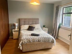 a bedroom with a bed and a window at Leixlip 4-Bed Home Sleeps 6 Ideal for Groups in Kildare