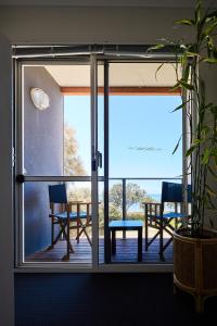 a sliding glass door with a table and chairs on a deck at Water's Edge 4x4 Townhouse in Falcon