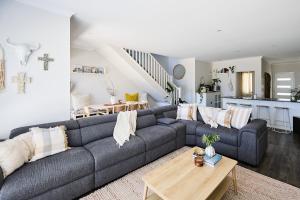 a living room with a gray couch and a table at Water's Edge 4x4 Townhouse in Falcon +37 photos