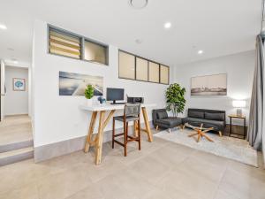 a living room with a desk with a computer at Executive Beachside Getaways in Maroochydore