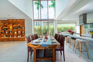 a kitchen with a wooden table and chairs at Diamond Beach Villa Da Nang in Danang