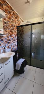 a bathroom with a sink and a glass shower at Canto da Lua in Lençóis +37 photos