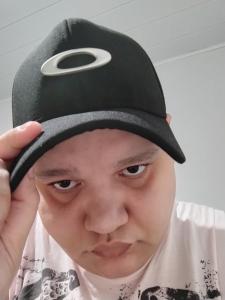 a young man wearing a black hat with a ring on it at Lara Araujo Dos Santos in Campo Grande
