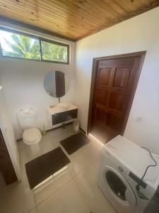a bathroom with a toilet and a sink and a mirror at Havaii Spot Huahine in HUH