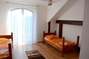 a bedroom with two beds and a window at Agrotur-Maya in Gorzyca
