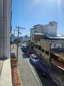 a street with cars parked next to a building at Brisa Do Mar in Saquarema