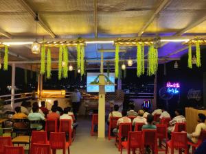a group of people sitting in chairs in a restaurant at The Gravity Inn in Indore