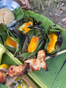 a plate of food on top of a banana leaf at Lazy mango homestay in Ban Mae Sapok Nua +75 photos