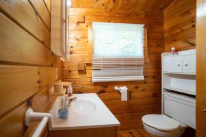 a bathroom with a sink and a toilet and a window at Stunning Lakeview Muskoka Pier 100 Resort in Port Carling +189 photos