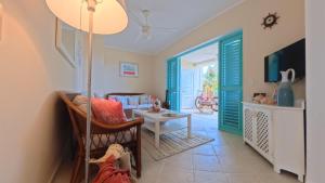 a living room with a couch and a table at La Dolce Vita Beachfront Apt 9 in Las Terrenas +20 photos