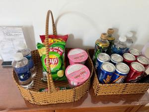 two baskets filled with drinks and soda on a table at Hùng Thi Hotel in Cái Răng