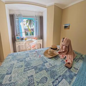 a bedroom with a bed with a hat on it at La Dolce Vita Beachfront Apt 9 in Las Terrenas