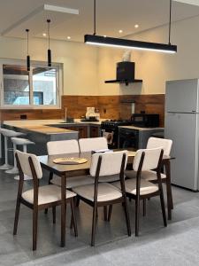 a kitchen with a table and chairs and a refrigerator at Altara Villa's in Ḩayl Yaman