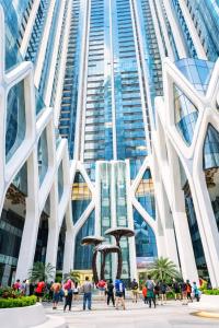 a group of people walking in front of a tall building at Thuý Doji Diamond Apartment in Hai Phong +40 photos