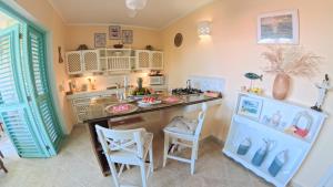 a kitchen with a counter and chairs in a room at La Dolce Vita Beachfront Apt 9 in Las Terrenas