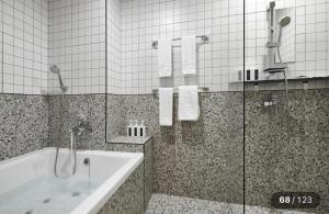 a bathroom with a bath tub and a shower at Just Sleep Hotel Jihaeng Station in Tongduch'ŏn +17 photos