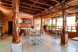 a restaurant with tables and chairs in a room at Esplendor by Wyndham Isla Mujeres Boutique All Inclusive in Isla Mujeres