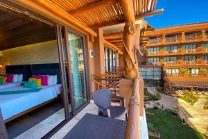 a balcony of a hotel with a bed and a bedroom at Esplendor by Wyndham Isla Mujeres Boutique All Inclusive in Isla Mujeres +201 photos