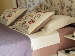 a bed with two pillows on top of it at Hotel blue Ocean 3 in Parnamirim