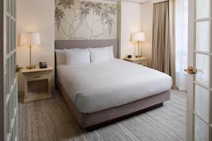a hotel room with a large bed and two tables at Wyndham Atlanta Perimeter in Atlanta +20 photos