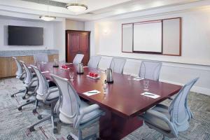 a conference room with a large wooden table and chairs at Wyndham Atlanta Perimeter in Atlanta