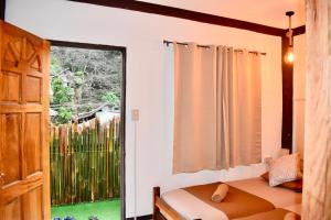 a bedroom with a bed and a large window at Apartment El Nido in El Nido